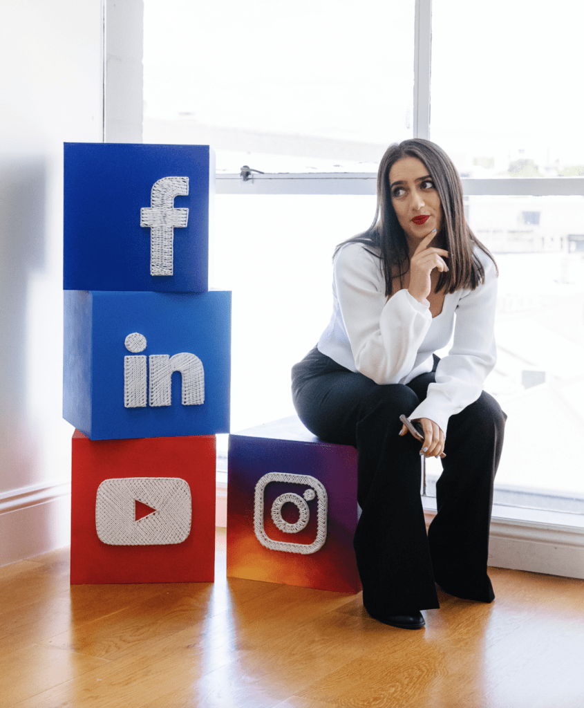 Social Media Marketing agecny owner posing with Facebook, LinkedIn, Youtube and Instagram icons