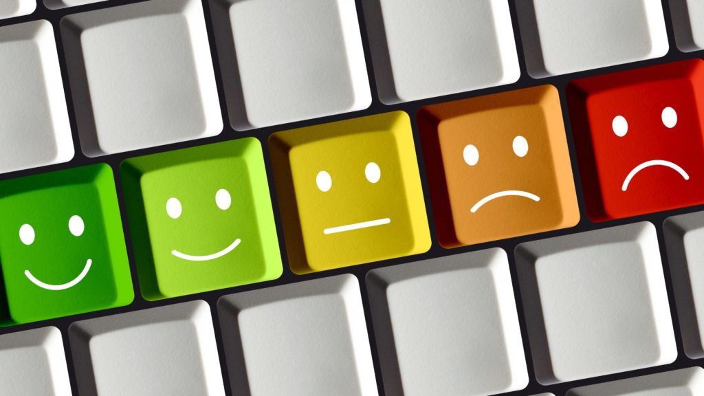 Keyboard keys in rainbow colour order with smiley faces on them